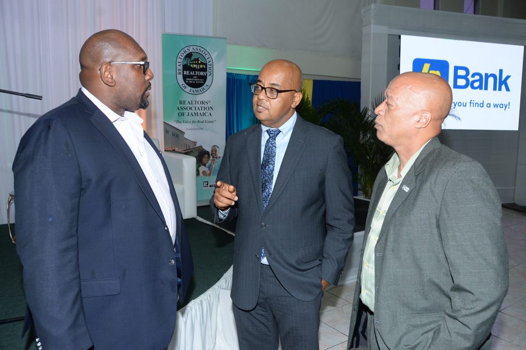 Gladstone Whitelocke (centre), Development Financing Specialist, Jamaica National Group, converses with Steve Distant (right), Chief of Retail Sales at JN Bank and Andrew James, President of the Realtors Association of Jamaica (RAJ), during the ‘Know Your Property Rights’ symposium, mounted by the RAJ at the Golf View Hotel in Mandeville recently. The event was sponsored by JN Bank.