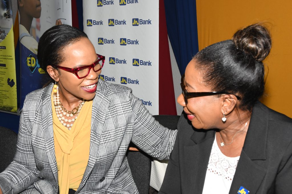 : Sandra Jones (right), Manager for Public Sector Engagement at JN Bank shares a light moment with Dr Kasan Troupe, Permanent Secretary in the Ministry of Education and Youth